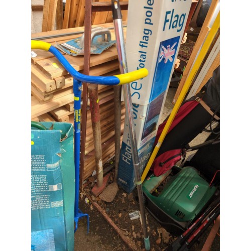 399 - Quantity of long handled tools including Level, Pickaxe, weeder, flag pole etc.