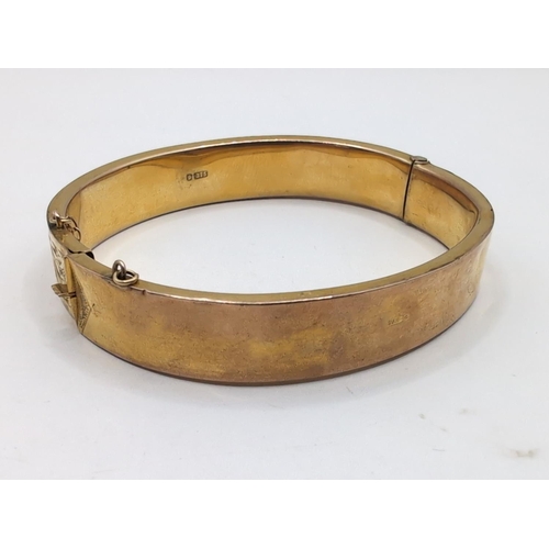 39 - 9ct gold hinged bracelet, hallmarked,&nbsp;with a foliate scroll pattern to one side, inner width 58... 
