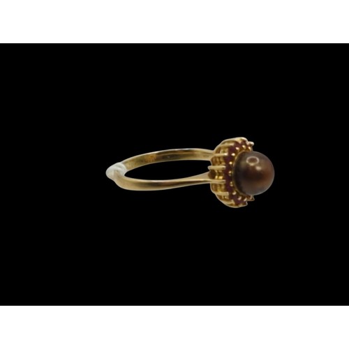 52 - Brown pearl and red stone cluster ring, in a yellow metal mount stamped 18K and 750, size T, gross w... 