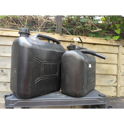 105 - 2 x black plastic petrol/diesel cans. Smaller is marked 10l.&nbsp;