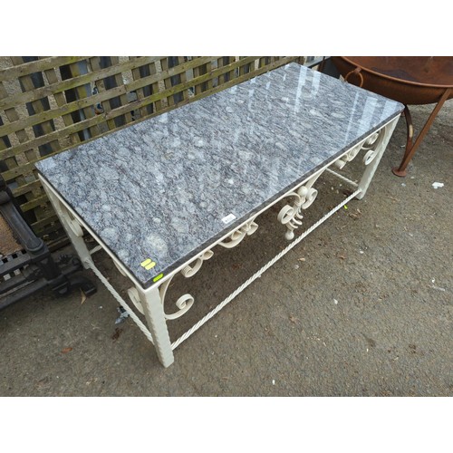 132 - Wrought iron garden table with polished granite top. W128cm D59cm H50cm.&nbsp;