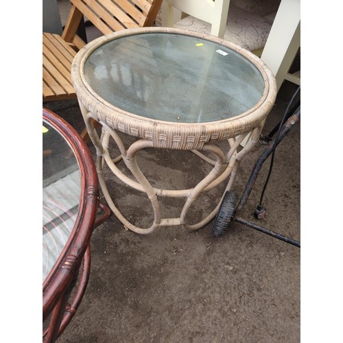 138 - Bamboo and wicker conservatory table with glass top. Dia56cm H56cm.&nbsp;