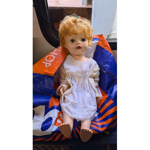 390 - Bag of dolls including gollies etc + Vintage Dolls pram with doll.