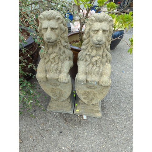 Pair of concrete lion statues holding shields. H81cm.