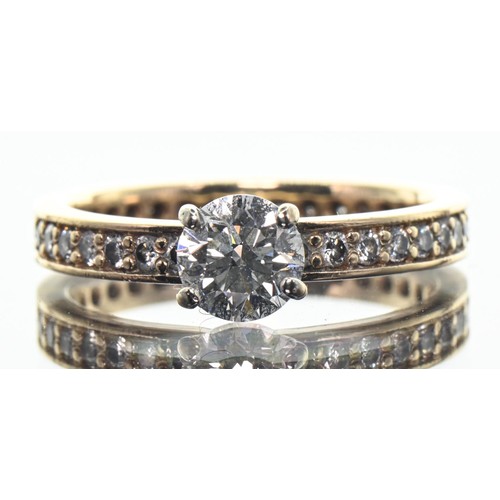 Diamond ring, centring an estimated 0.96 carat (E/F VS1/VS2) round brilliant-cut diamond to a yellow metal band set all around with thirty-four brilliant-cut diamonds together estimated to weigh 0.35 carat, the yellow metal band tested as 18ct gold, size S1/2, gross weight 4.3 grams