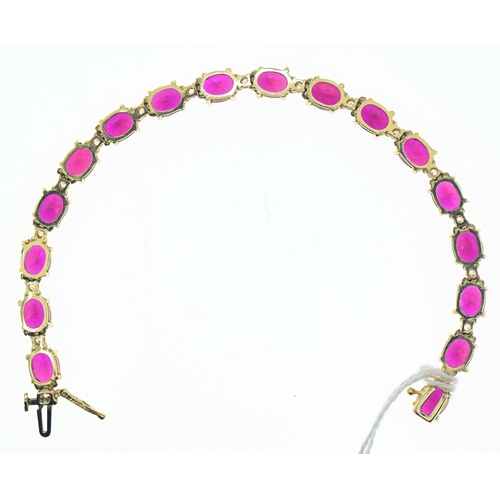 44 - Red stone and white stone line bracelet, in a yellow metal setting marked '14K', length 185mm, gross... 