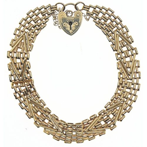 57 - 9ct gold fancy brick link bracelet with a heart-shaped padlock clasp, hallmarked, with safety chain,... 