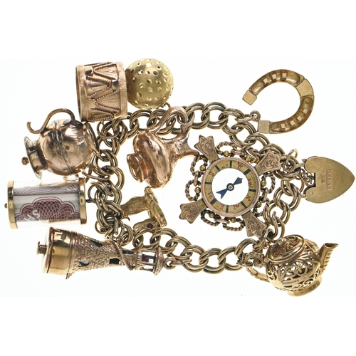 61 - 9ct gold hallmarked charm bracelet with a heart-shaped padlock clasp, suspending nine 9ct gold hallm... 