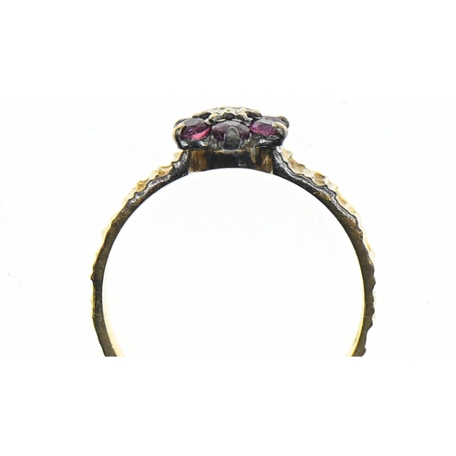 68 - 18ct gold, ruby and diamond flowerhead ring, hallmarked, with texture band, size N1/2, gross weight ... 