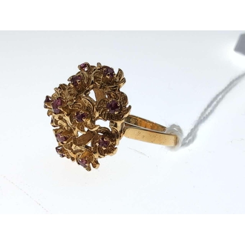 104 - Yellow metal and ruby floral cluster ring, marked '18CT' size L, gross weight 7.2 grams