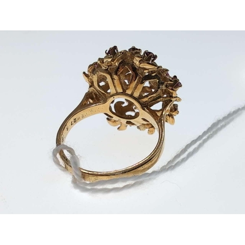 104 - Yellow metal and ruby floral cluster ring, marked '18CT' size L, gross weight 7.2 grams