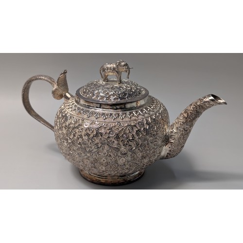 327 - Indian white metal three-piece tea set, the globular bodies with foliate decoration, cobra handles a... 