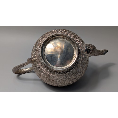 327 - Indian white metal three-piece tea set, the globular bodies with foliate decoration, cobra handles a... 