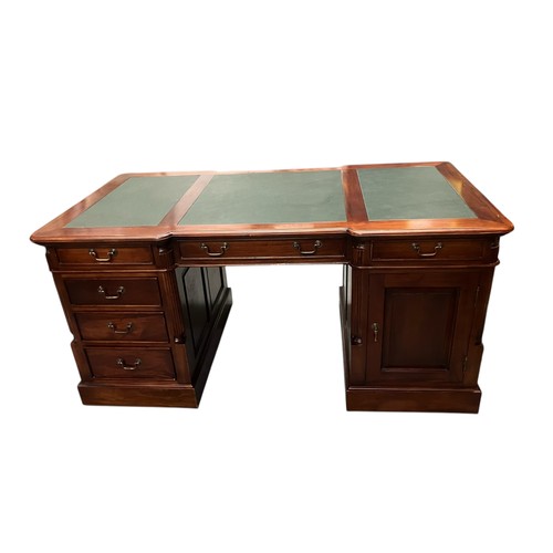 Mahogany green leather-topped partners desk with 6 drawers and 1 cupboard to each side. W160cm D84cm H77cm.