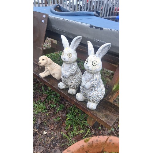 117 - Set of 3 garden ornaments comprising a pair of rabbit figures with pebble-textured bodies and large ... 