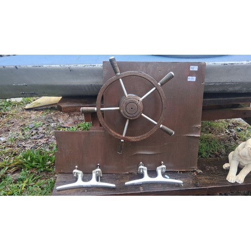 118 - Collection of small-boat fittings, including two aluminium cleats and a timber-mounted helm wheel wi... 