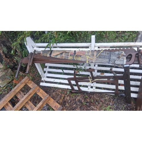 119 - Group of vintage woodworking tools, including two-man crosscut saws with wooden handles, frame/buck ... 