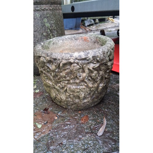 70 - A cast stone garden planter of squat cylindrical form, the exterior moulded in relief with foliate s... 