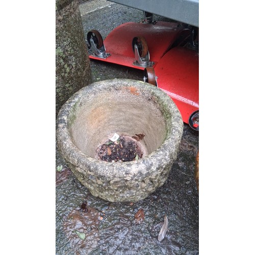 70 - A cast stone garden planter of squat cylindrical form, the exterior moulded in relief with foliate s... 