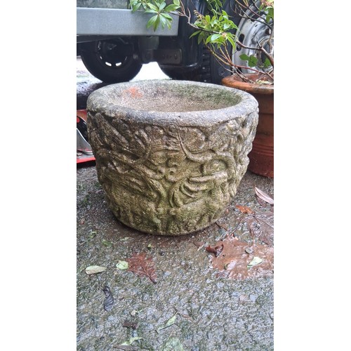 70 - A cast stone garden planter of squat cylindrical form, the exterior moulded in relief with foliate s... 