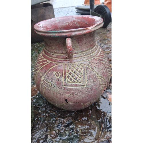 79 - A terracotta amphora-form vessel with wide flared rim and twin loop handles, the globular body incis... 