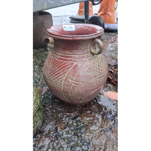 79 - A terracotta amphora-form vessel with wide flared rim and twin loop handles, the globular body incis... 