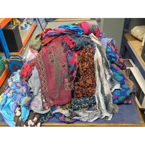 Group of assorted scarves and wraps in mixed textiles, comprising woven ...