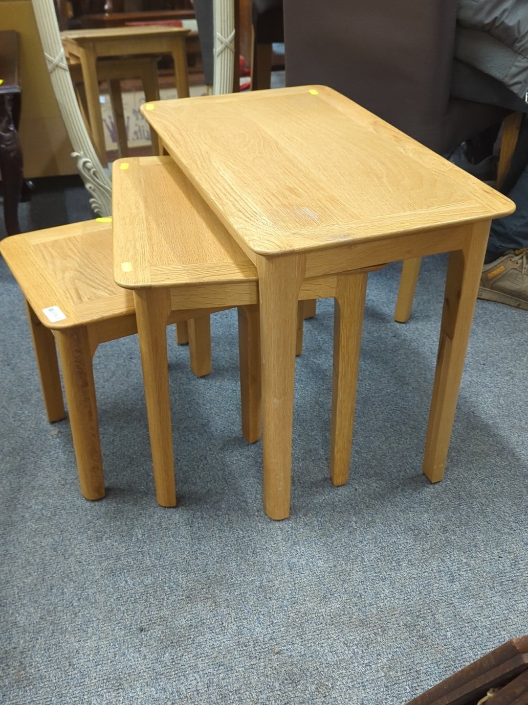 Set of three light oak nest of tables, each of rectangular form with ...