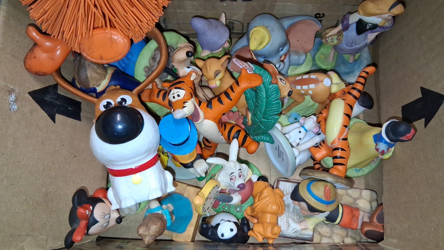 A group of assorted animal figurines and character toys, including dogs ...