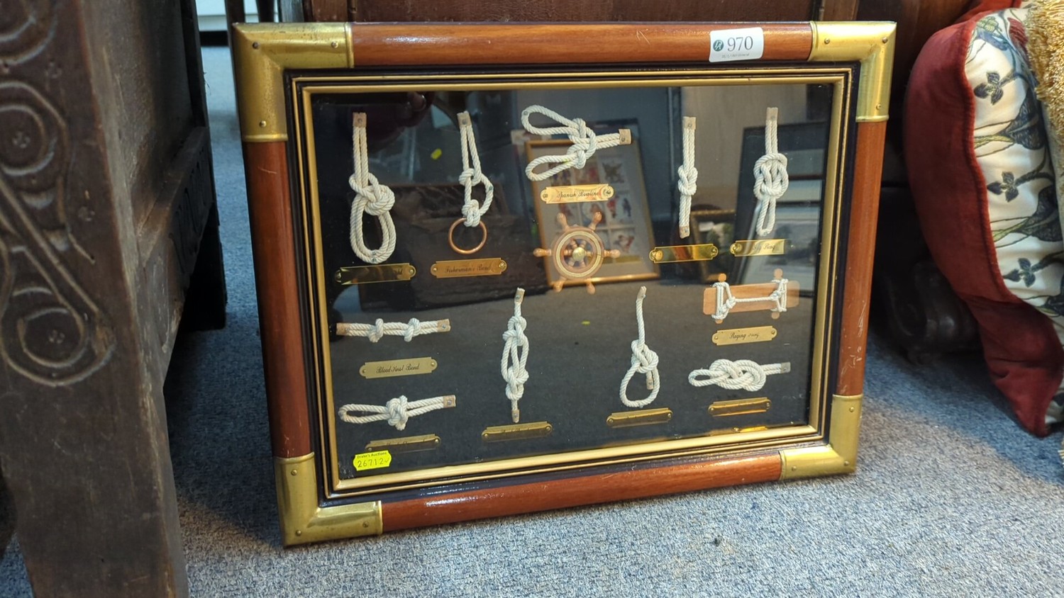 A framed nautical display case presenting knotted ropework studies with ...