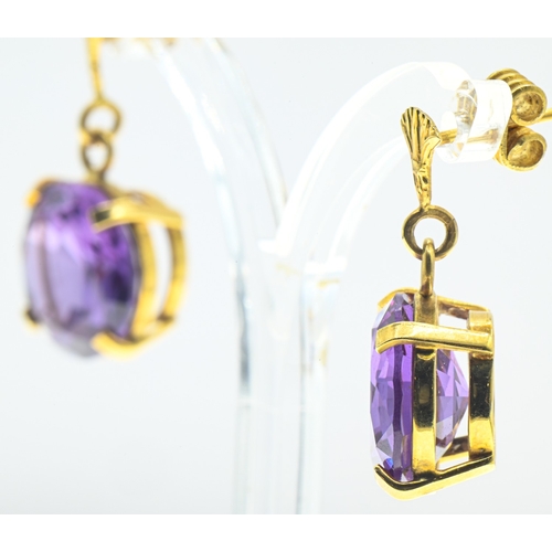 3 - Pair of synthetic purple sapphire pendant earrings, each surmount with an Egyptian lotus flower moti... 