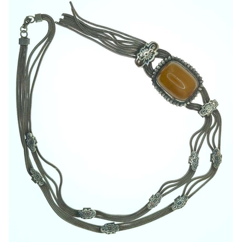 6 - Silver tassel necklace set with a butterscotch amber coloured bead, marked '925', gross weight 60 gr... 