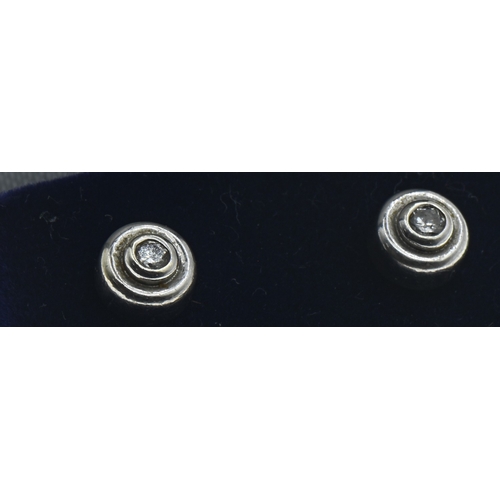 32 - Pair of 9ct white gold and diamond ear studs, hallmarked, diameter 6mm, gross weight 1.45 grams... 