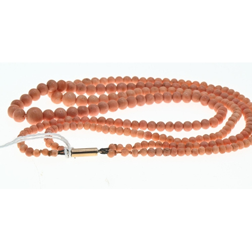 34 - Double strand graduated coral necklace, with a yellow metal barrel clasp marked '9CT', inner strand ... 