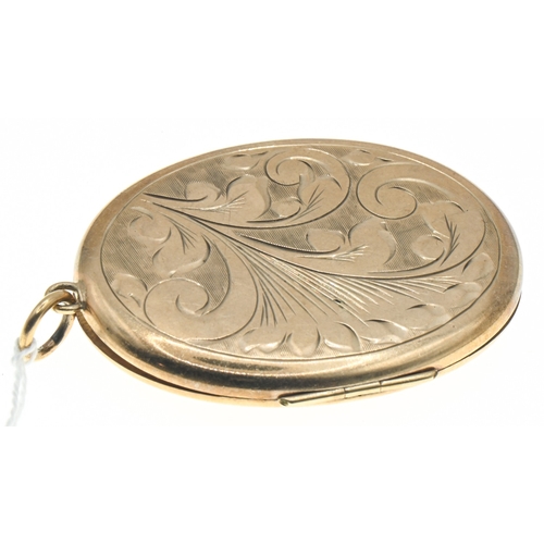 35 - Large 9ct gold oval locket, hallmarked,&nbsp;with foliate pattern to the front, length including bal... 