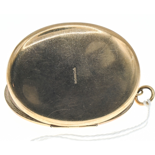 35 - Large 9ct gold oval locket, hallmarked,&nbsp;with foliate pattern to the front, length including bal... 