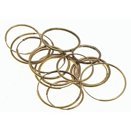 44 - Yellow metal sleeper hoop earrings, including six pairs and three single, gross weight 2 grams
