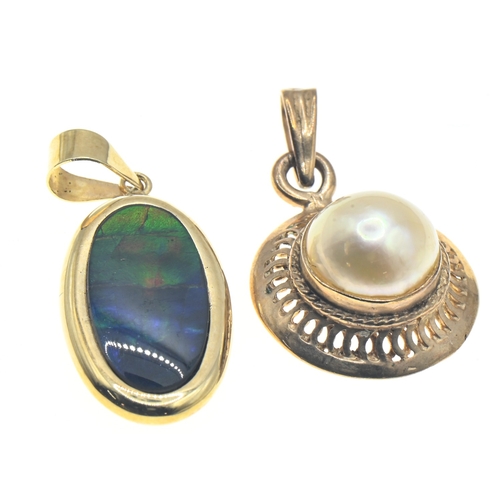 55 - Two yellow metal mounted pendants, including one set with butterfly wing marked '14K' and another wi... 