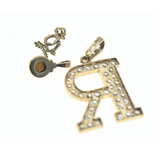 57 - Two 9ct gold hallmarked pendants, including a CZ set initial 'R' and pearl set, largest length 38mm,... 