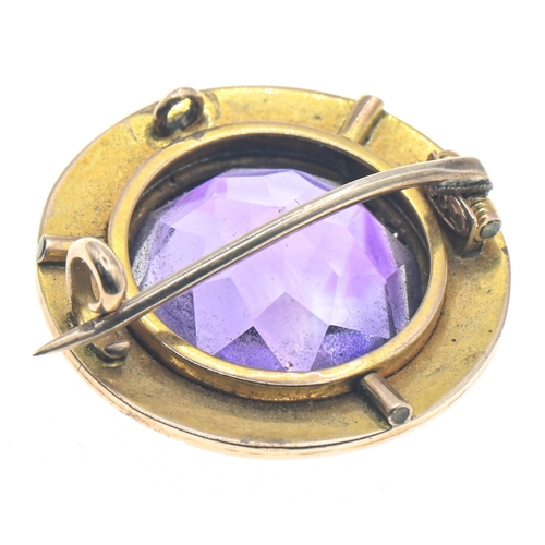 76 - Amethyst and seed pearl set circular brooch, marked '9CT', diameter 20mm, gross weight 4.35 grams... 