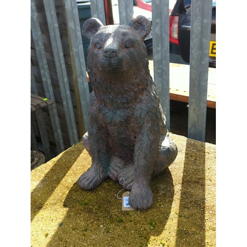 Garden sculpture seated bear cub.