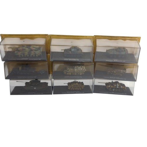 A group of die-cast military vehicle scale models, each mounted on a ...