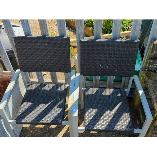11 - A pair of contemporary garden armchairs, each with a grey metal frame and open arms, the seat and re... 