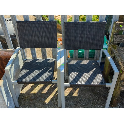 11 - A pair of contemporary garden armchairs, each with a grey metal frame and open arms, the seat and re... 