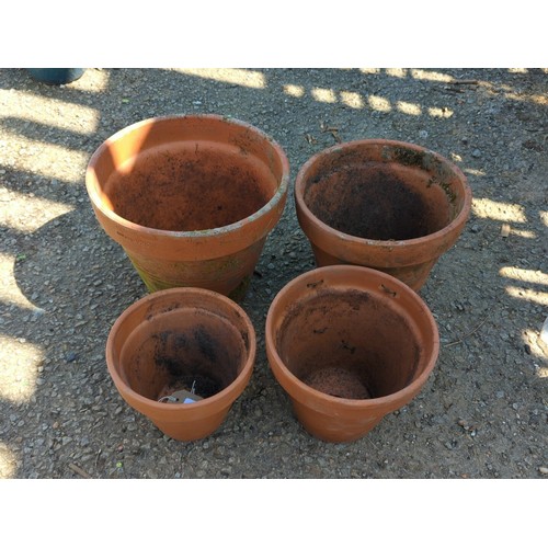 2 - A group of terracotta garden planters of tapering circular form with broad rolled rims, comprising a... 