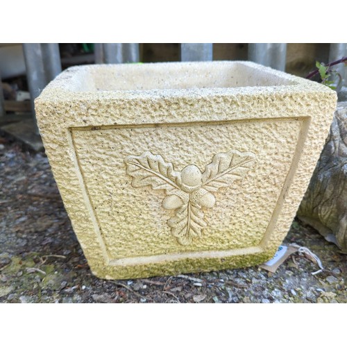 20 - Two concrete garden planters: one square trough with pebbled ground and relief oak-leaf cartouche; t... 