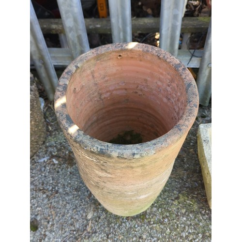 21 - Large terracotta garden planter of tapering cylindrical form with a single drainage aperture near th... 