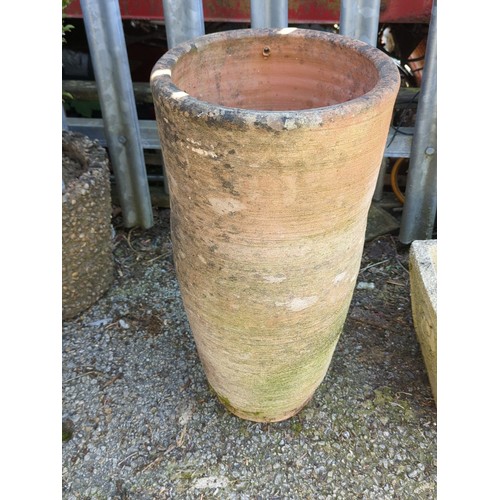 21 - Large terracotta garden planter of tapering cylindrical form with a single drainage aperture near th... 