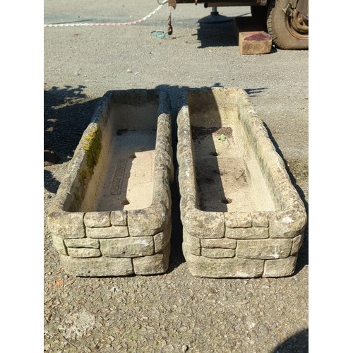 33 - A pair of concrete trough planters of rectangular form with simulated rusticated blockwork sides, ea... 
