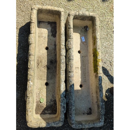 33 - A pair of concrete trough planters of rectangular form with simulated rusticated blockwork sides, ea... 